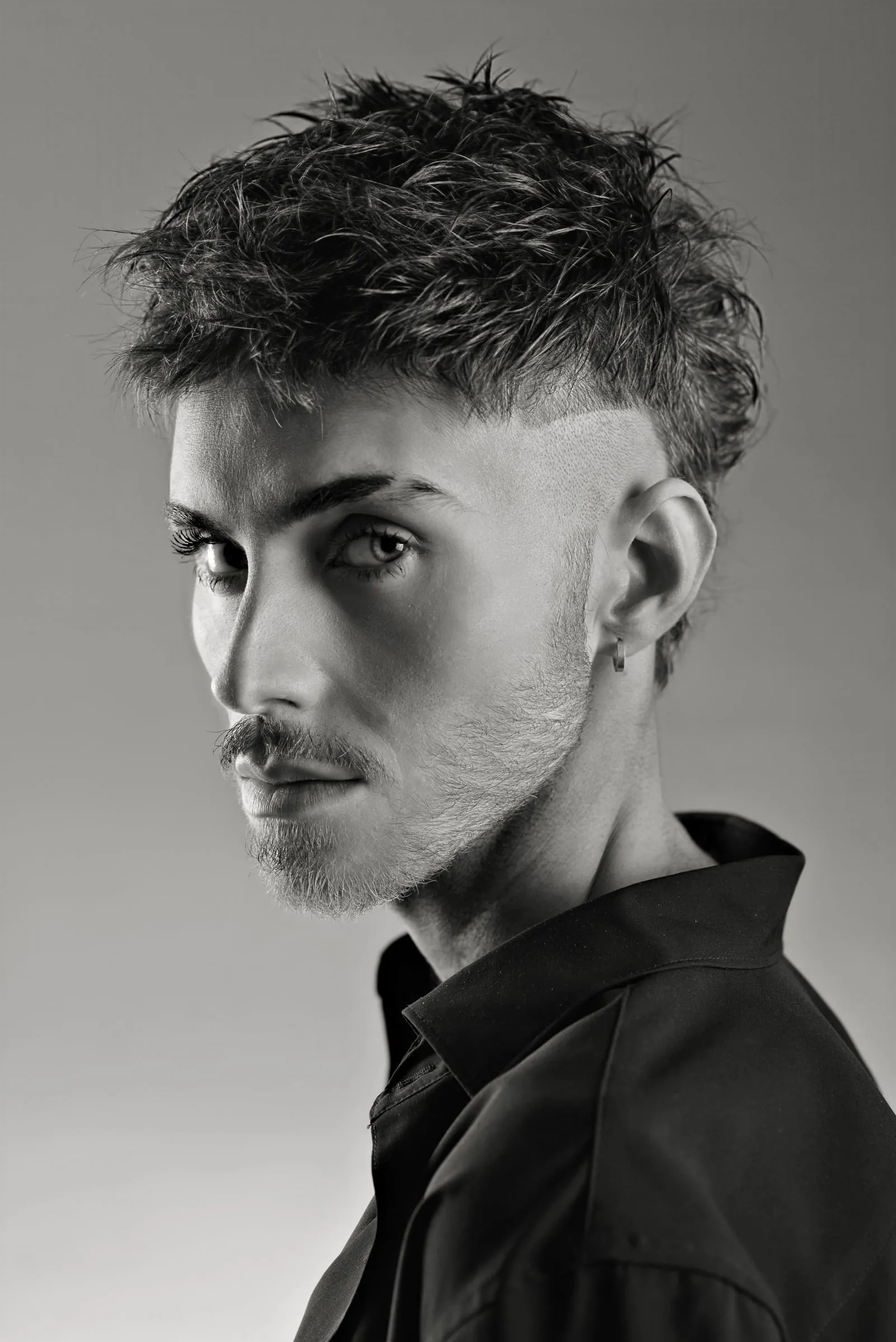 Textured crop with faded sides and a hard part line shaved above the ear