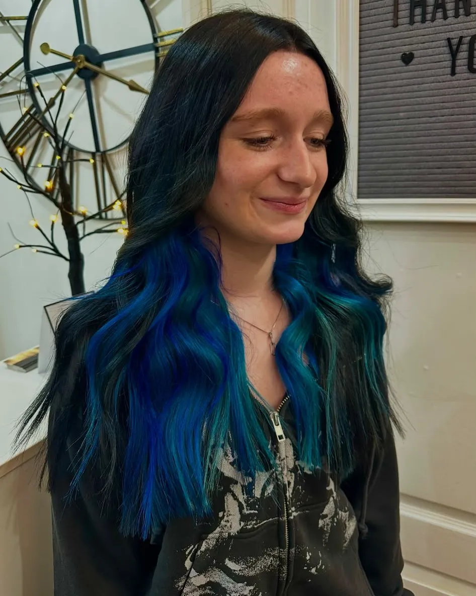 Black roots melting into electric blue and teal on long, straight lengths